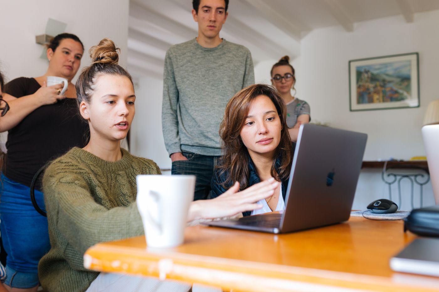A small team working together around a laptop