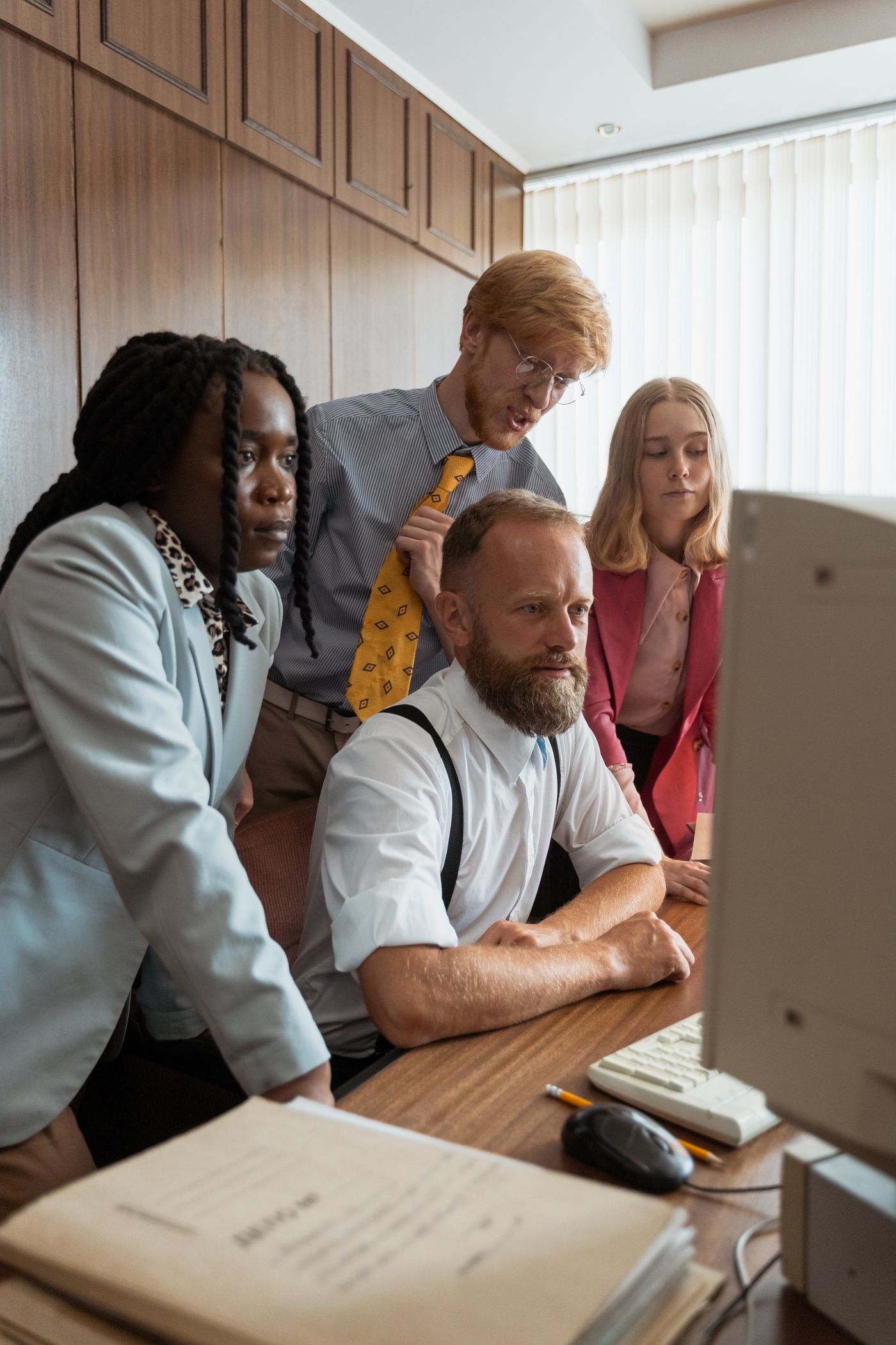 A consultant reviewing figures on screen with colleagues