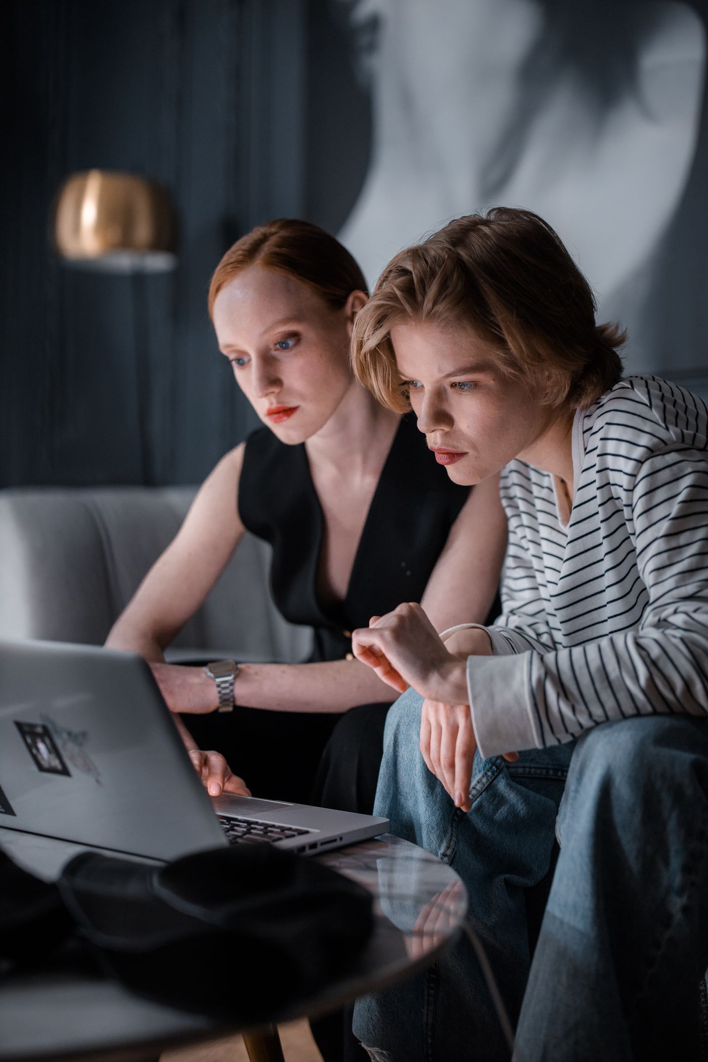 Two freelancers working late on a laptop