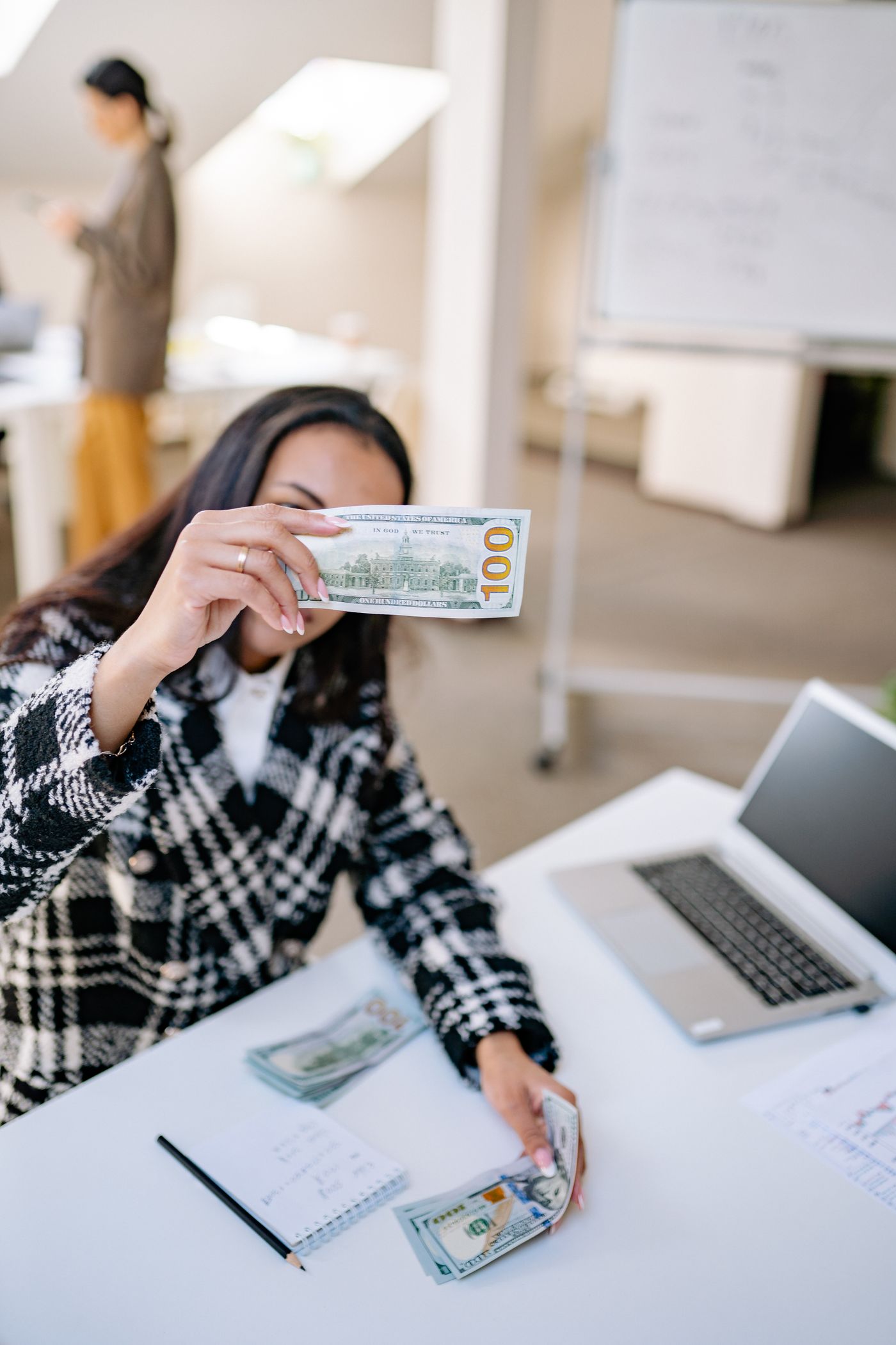 A creator counting payments at a desk